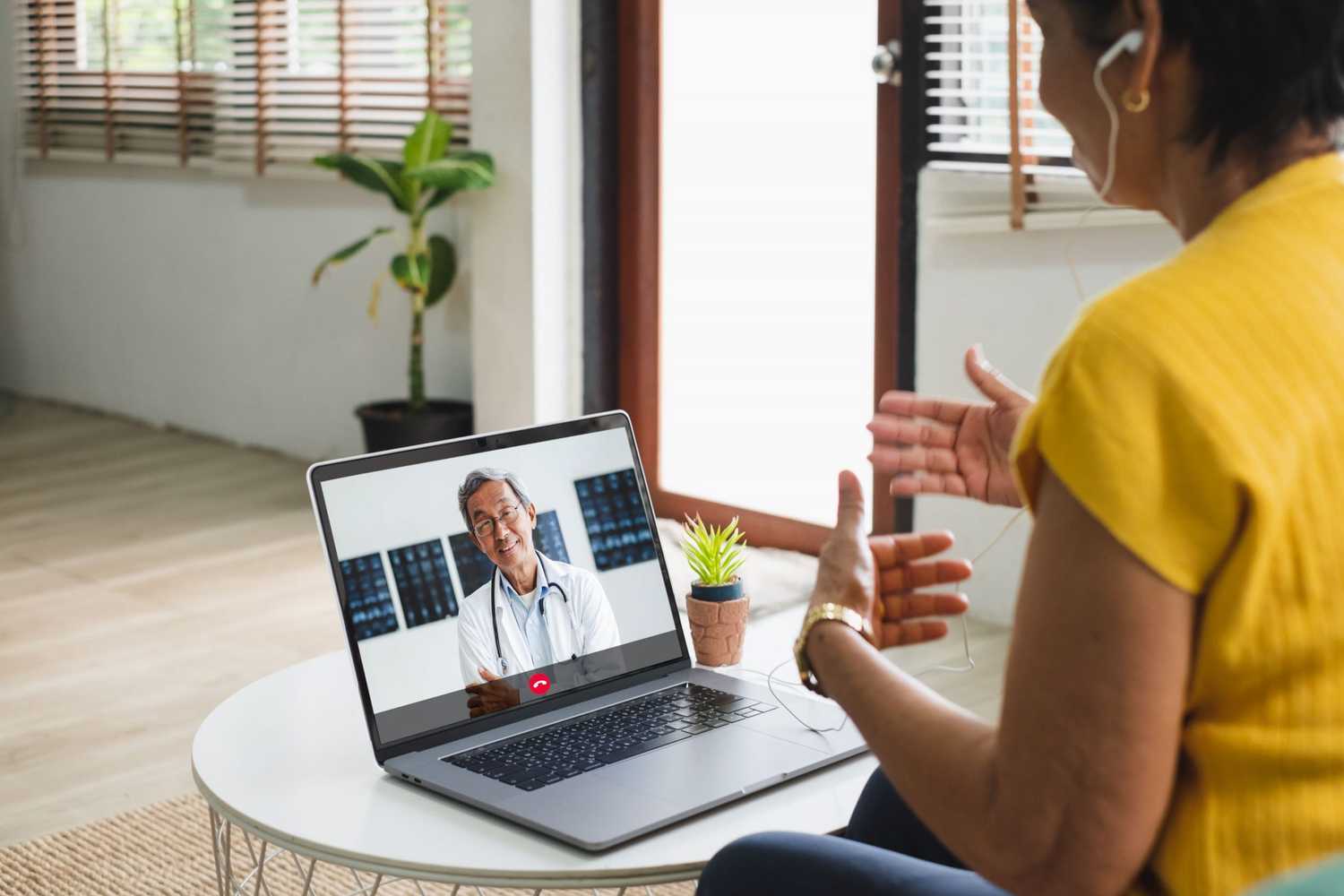 A person at home on a telehealth visit with a doctor