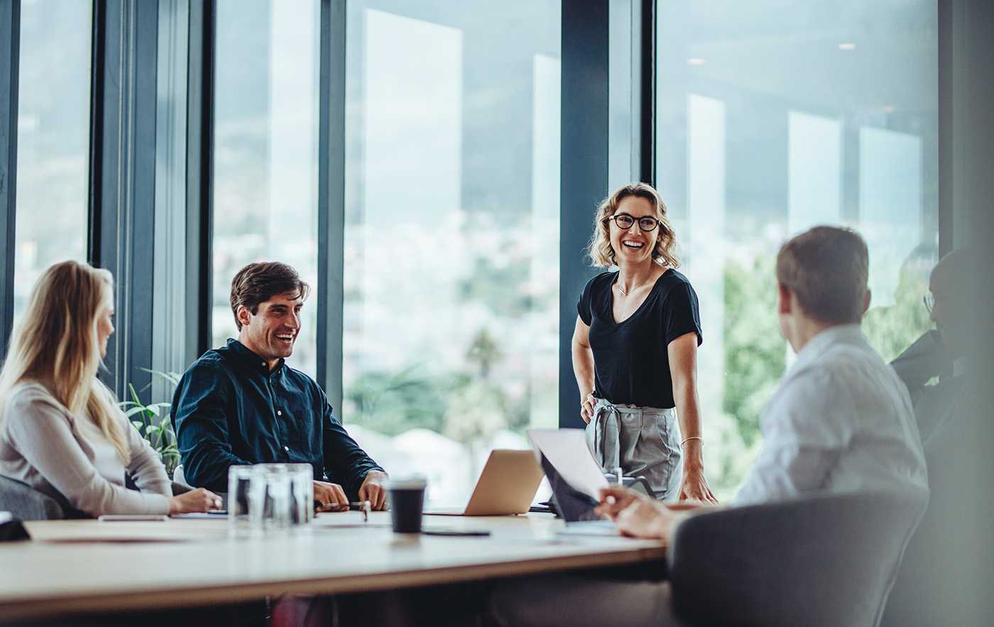 group of professionals in a conference room discussing corvel investors updates