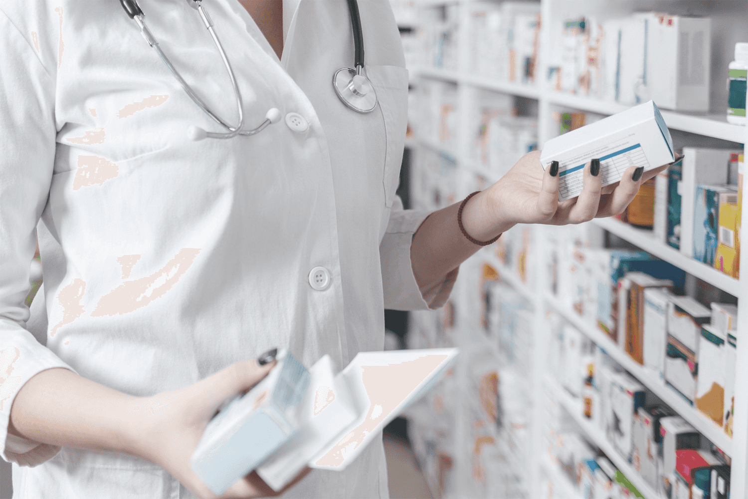 Woman pharmacist holding prescription checking medicine in pharmacy - drugstore.