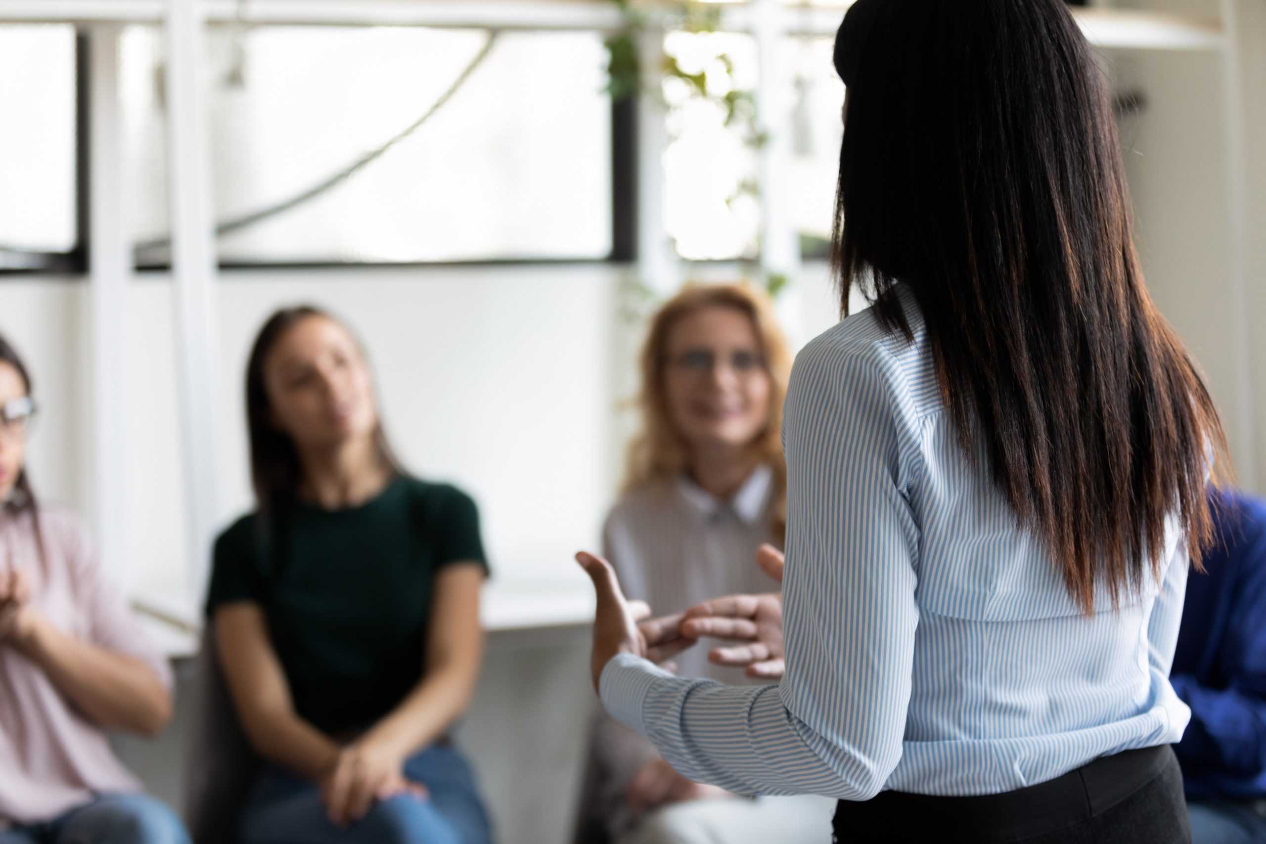 a female counselor leading a group appointment for critical incident stress debriefing