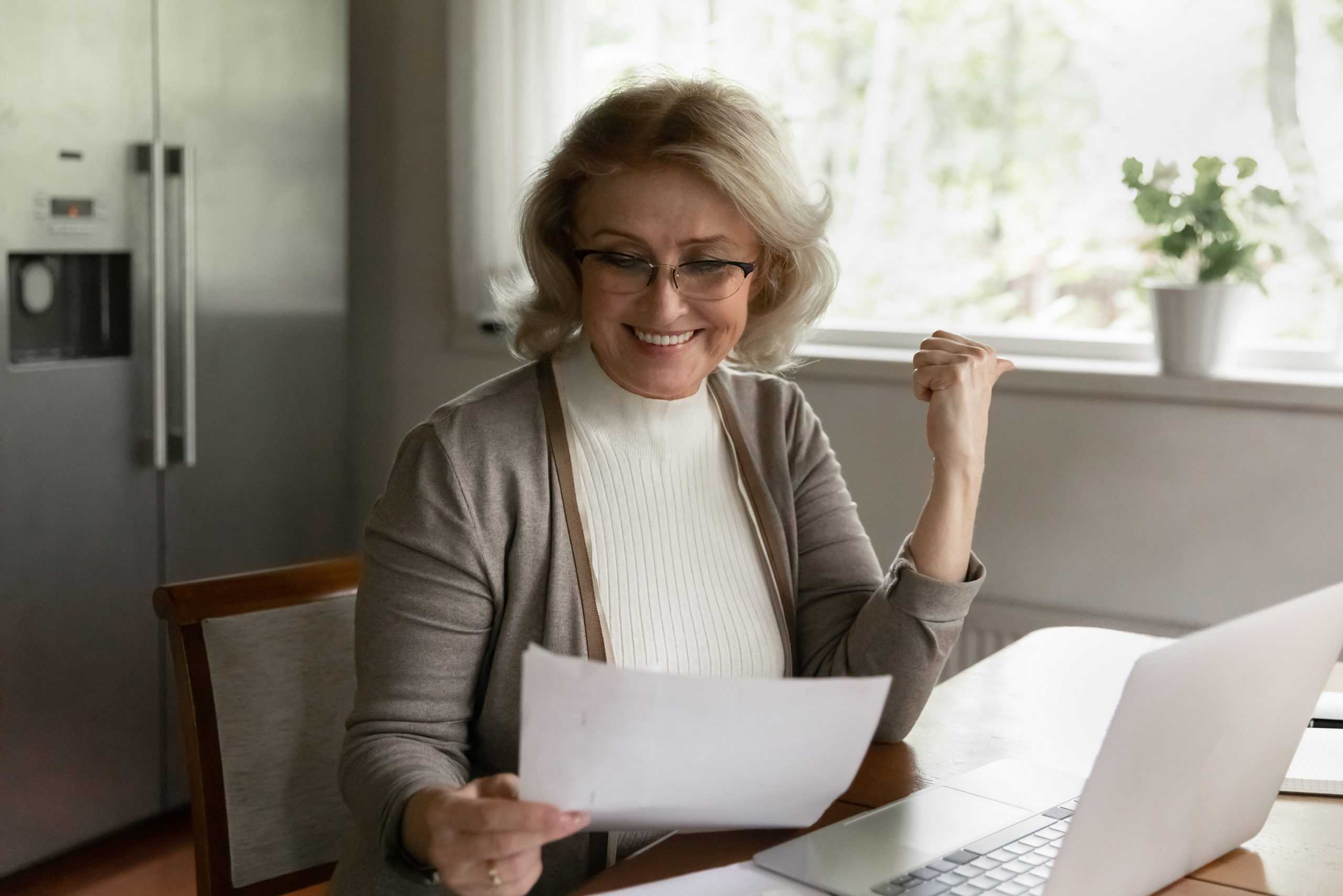 a happy senior woman reviewing her corvel workers comp medicare service report