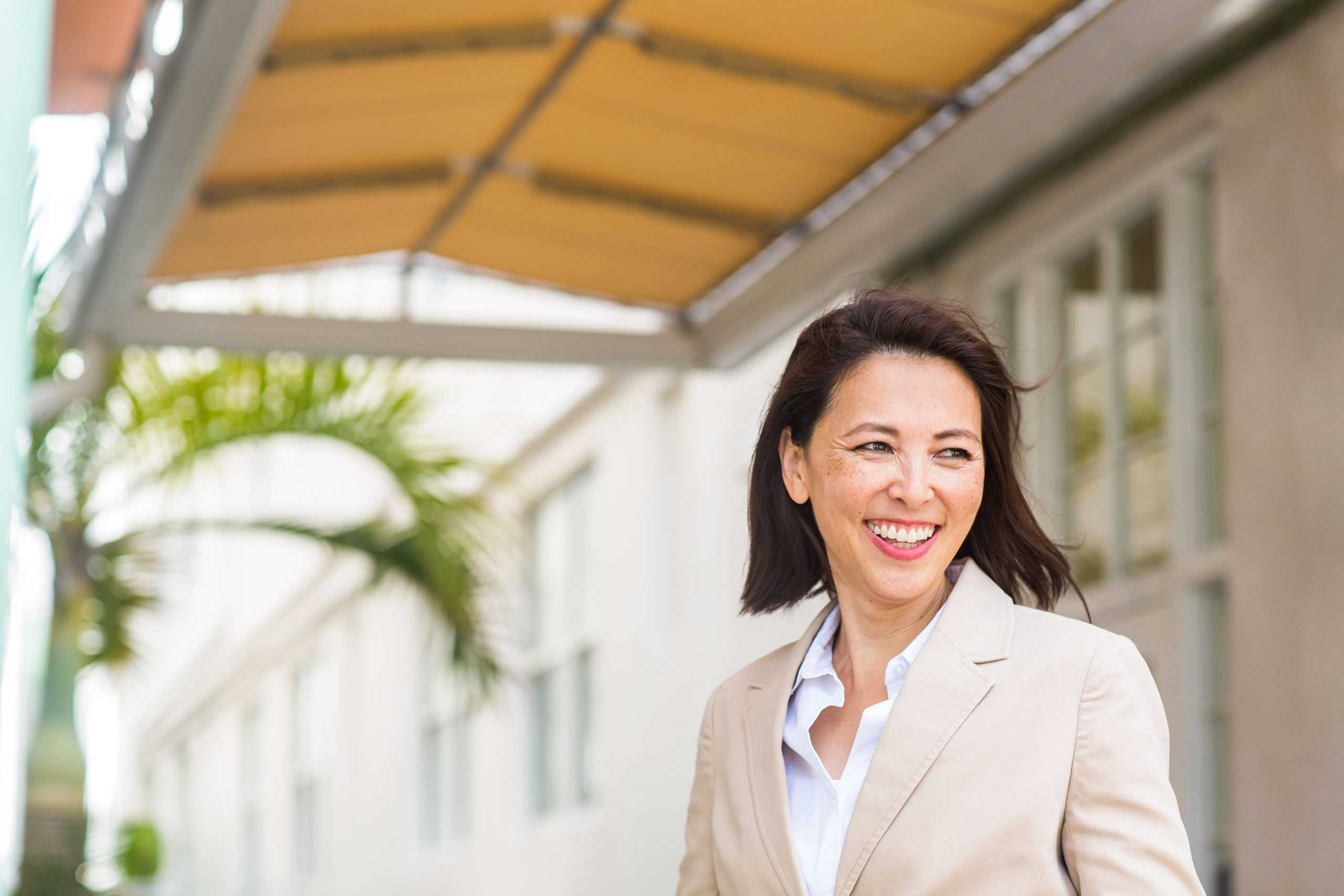 a happy female workers comp legal nurse consultant walking out of her office