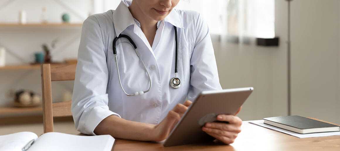 A doctor using a tablet for virtual care services