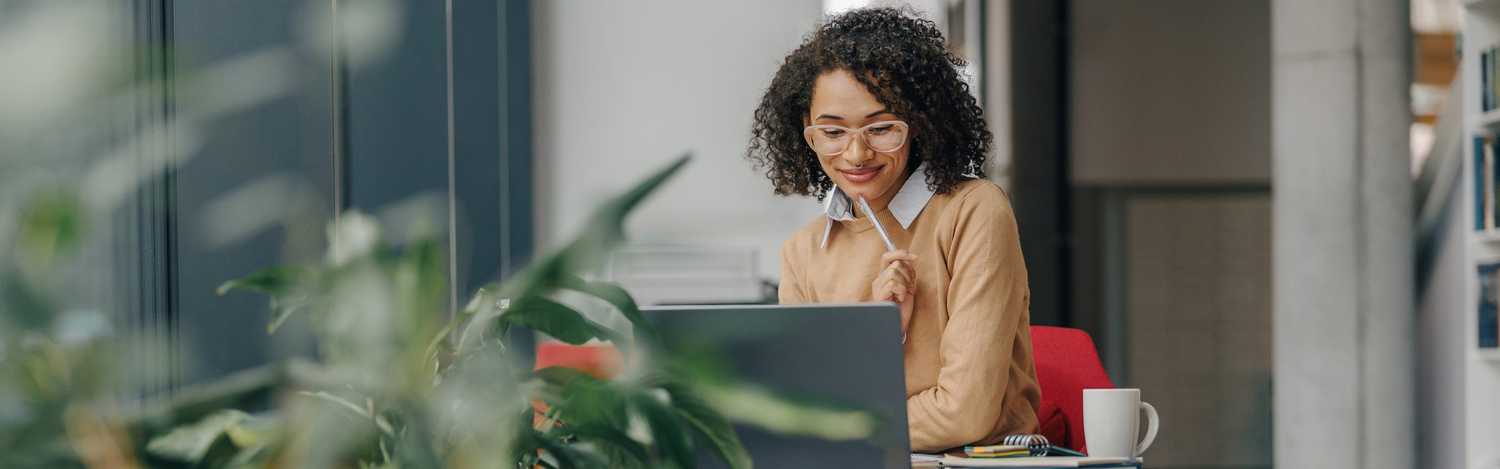 Case manager reviewing information on a laptop to coordinate care and support injured workers throughout the workers’ compensation recovery process.