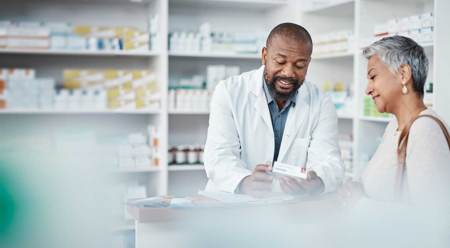 A pharmacist consulting a patient on an alternative to high cost topical medications.