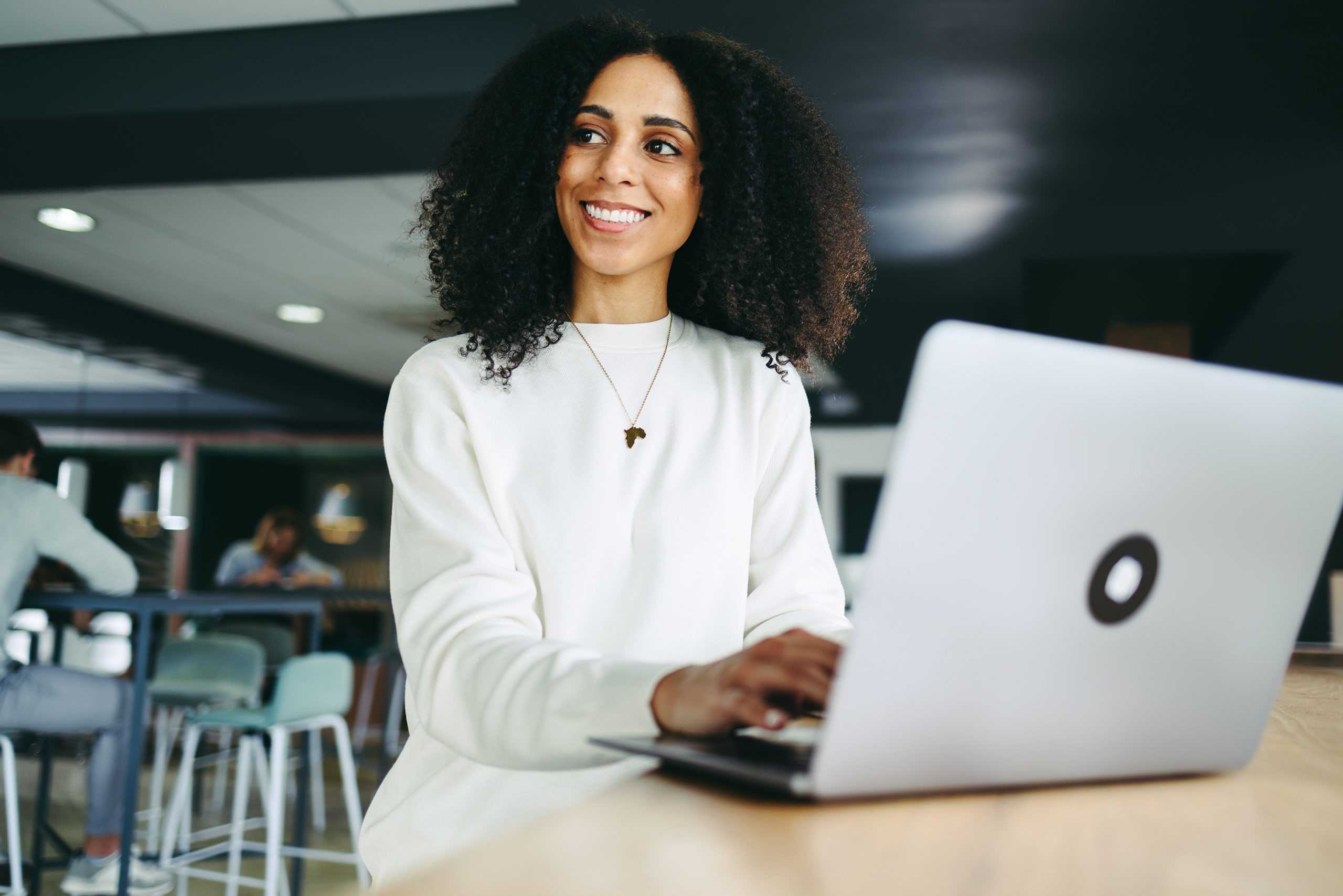 young happy businesswoman on computer learning about corvel's bill review services