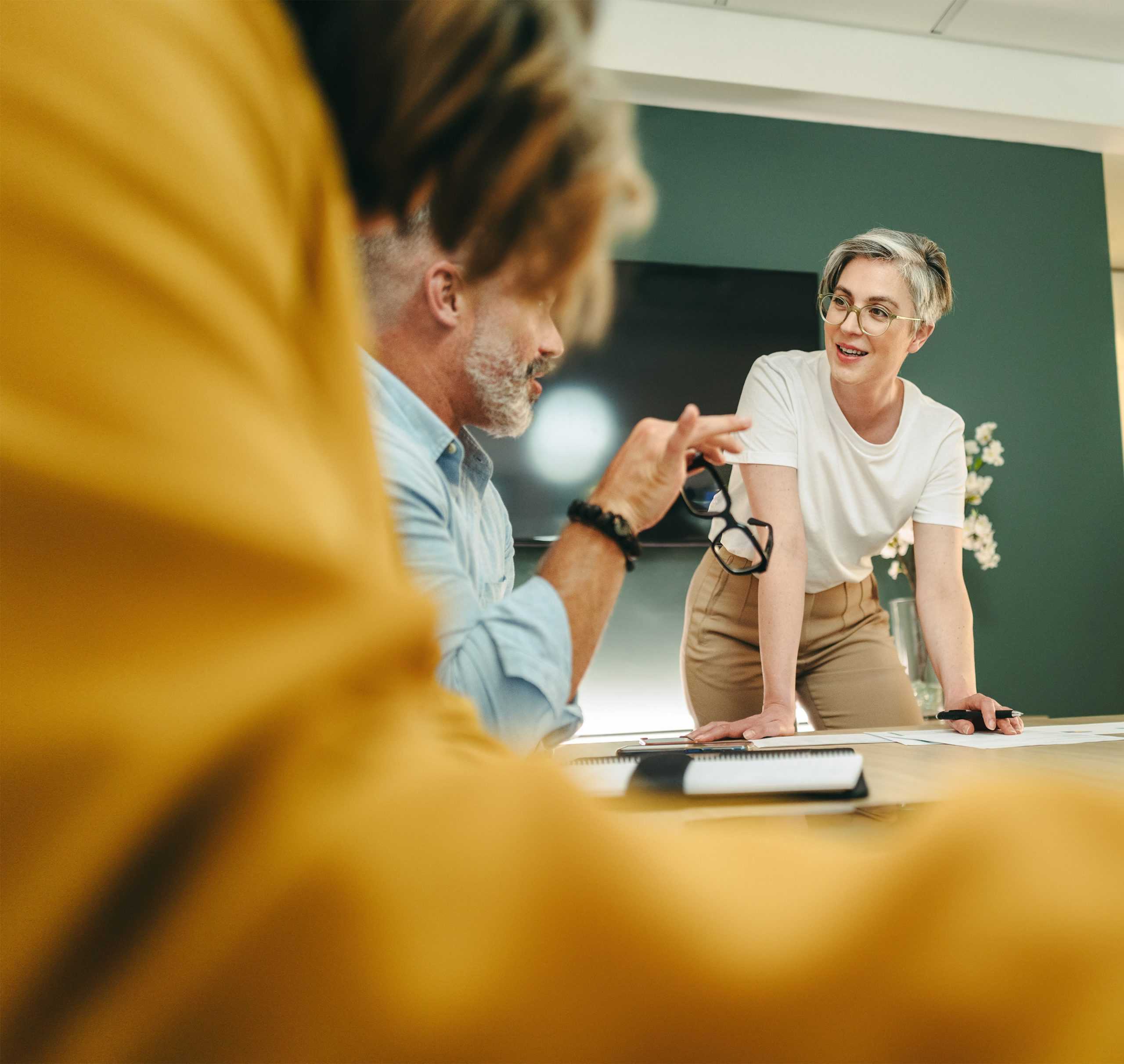 two professionals at a table discussing workers comp disability management services