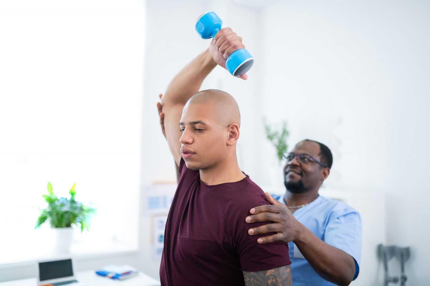 A physical therapist helping a man do an arm stretch