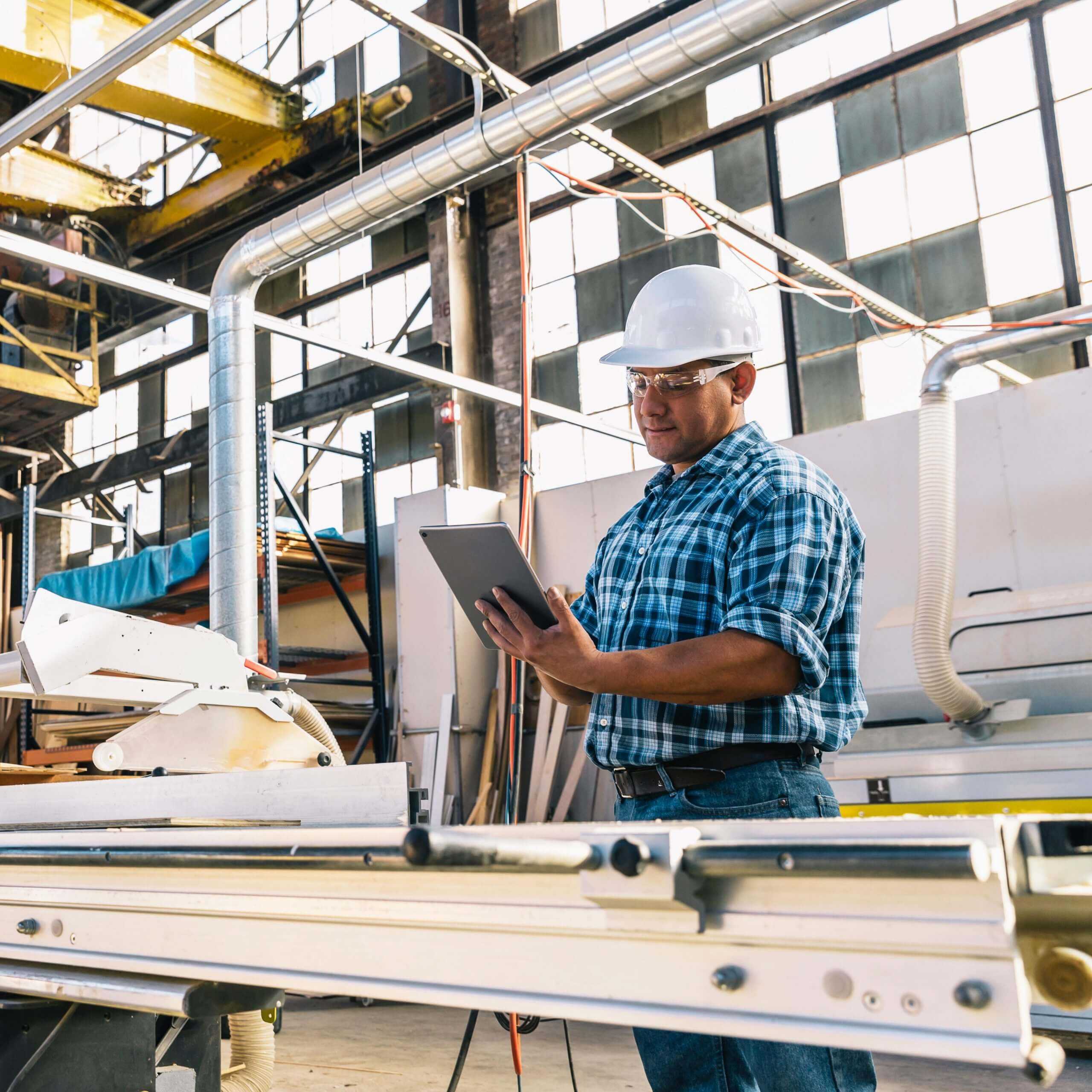 construction worker reviewing corvel's alternative risk solutions on tablet